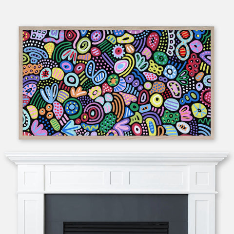 Abstract painting featuring colorful graffiti patterns on black background displayed full screen in Samsung Frame TV above fireplace