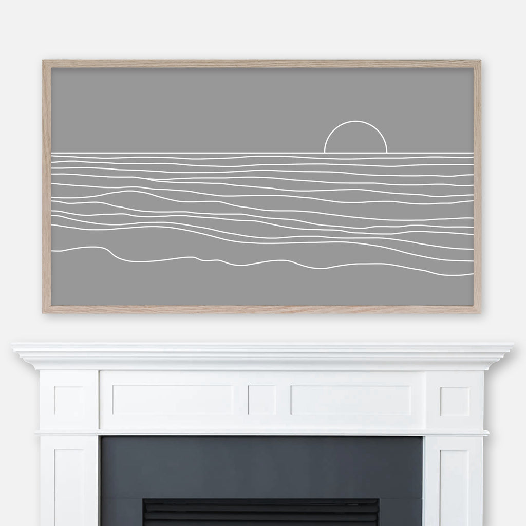 Neutral medium gray and white beach sunset line artwork displayed full screen in Samsung Frame TV above fireplace