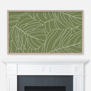 Olive green and white monstera leaf pattern line art displayed full screen in Samsung Frame TV above fireplace