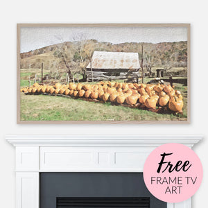 Free Frame TV Art Download - Digital watercolor landscape painting of a pumpkin country farm and rustic cabin displayed above fireplace