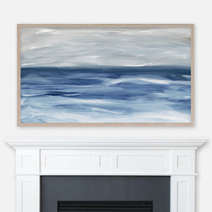Navy blue and gray ocean waves abstract landscape painting displayed full screen in Samsung Frame TV above fireplace