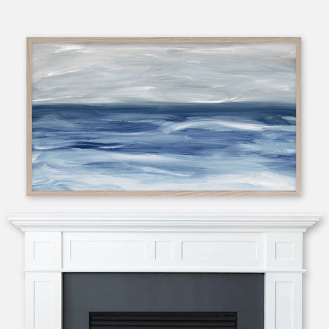 Navy blue and gray ocean waves abstract landscape painting displayed full screen in Samsung Frame TV above fireplace