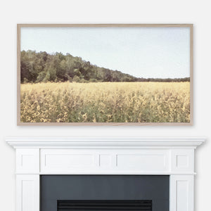 Yellow flowers field watercolor landscape painting displayed in Samsung Frame TV above fireplace