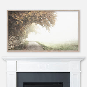Watercolor landscape painting of a country path along a stone wall with trees displayed in Samsung Frame TV above fireplace