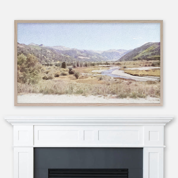 Colorado mountains and meadow watercolor painting displayed full screen in Samsung Frame TV above fireplace