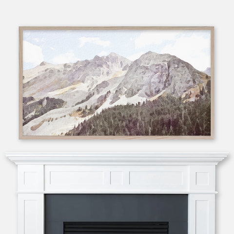 Watercolor landscape painting of Colorado Rocky Mountains and pine trees displayed in Samsung Frame TV above fireplace