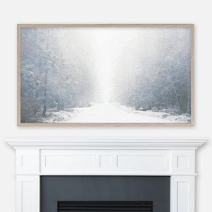 Watercolor winter landscape painting of a foggy snowy forest path displayed in Samsung Frame TV above fireplace
