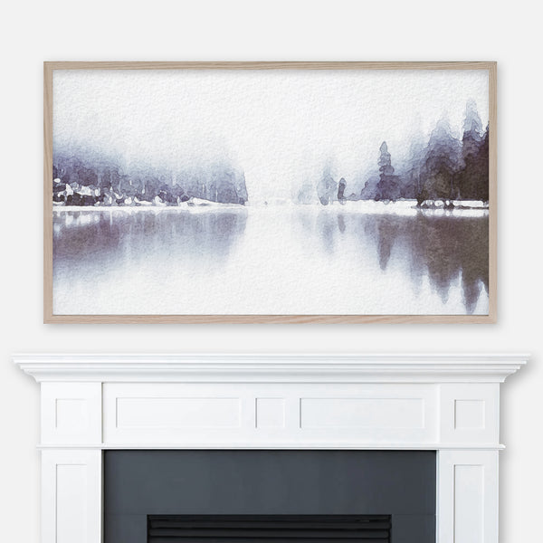 Watercolor winter landscape painting of a foggy lake and pine trees displayed in Samsung Frame TV above fireplace