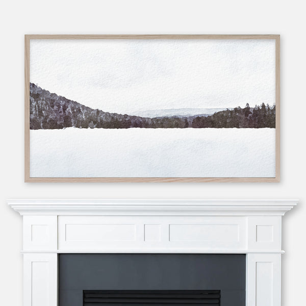 Watercolor winter landscape painting of a snowy forest lake displayed in Samsung Frame TV above fireplace
