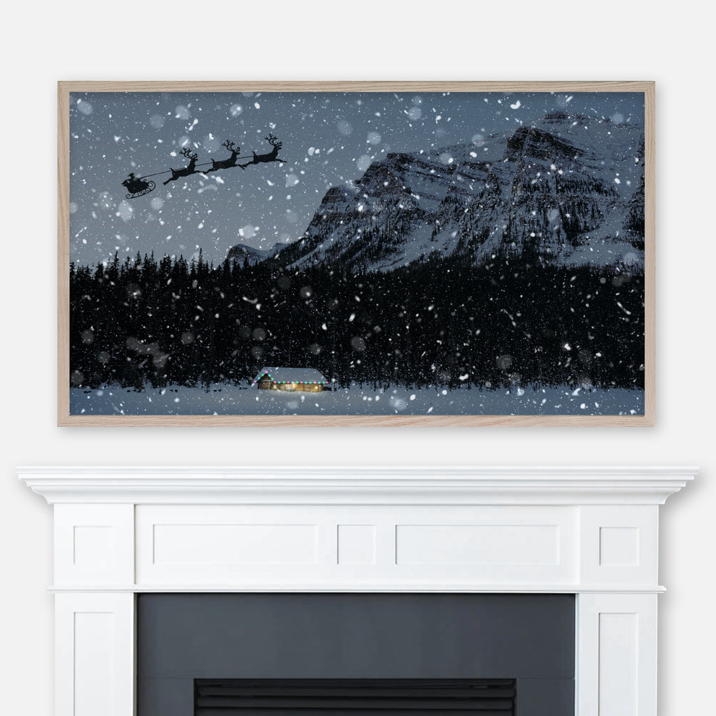 Christmas Samsung Frame TV Art 4K - Santa’s Sleigh in the Sky Over an Illuminated Cabin with Forest & Mountain on a Snowy Night - Digital Download